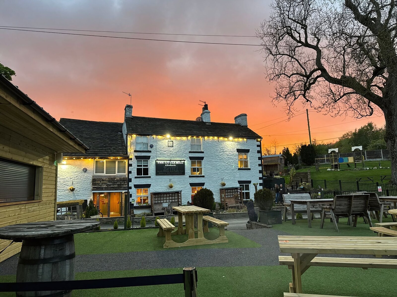 The Little Mill Inn under festoon lights at dusk, Rowarth