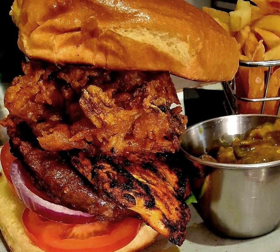 A char-grilled chicken burger with chunky chips