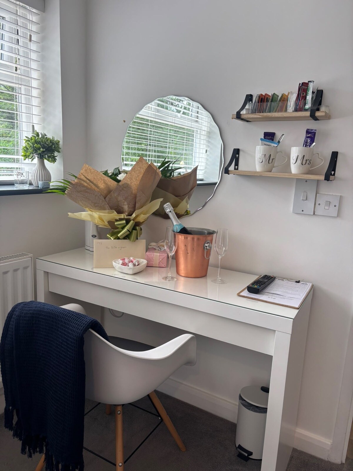 Dressing table dressed with flowers, champagne bucket and welcome gifts