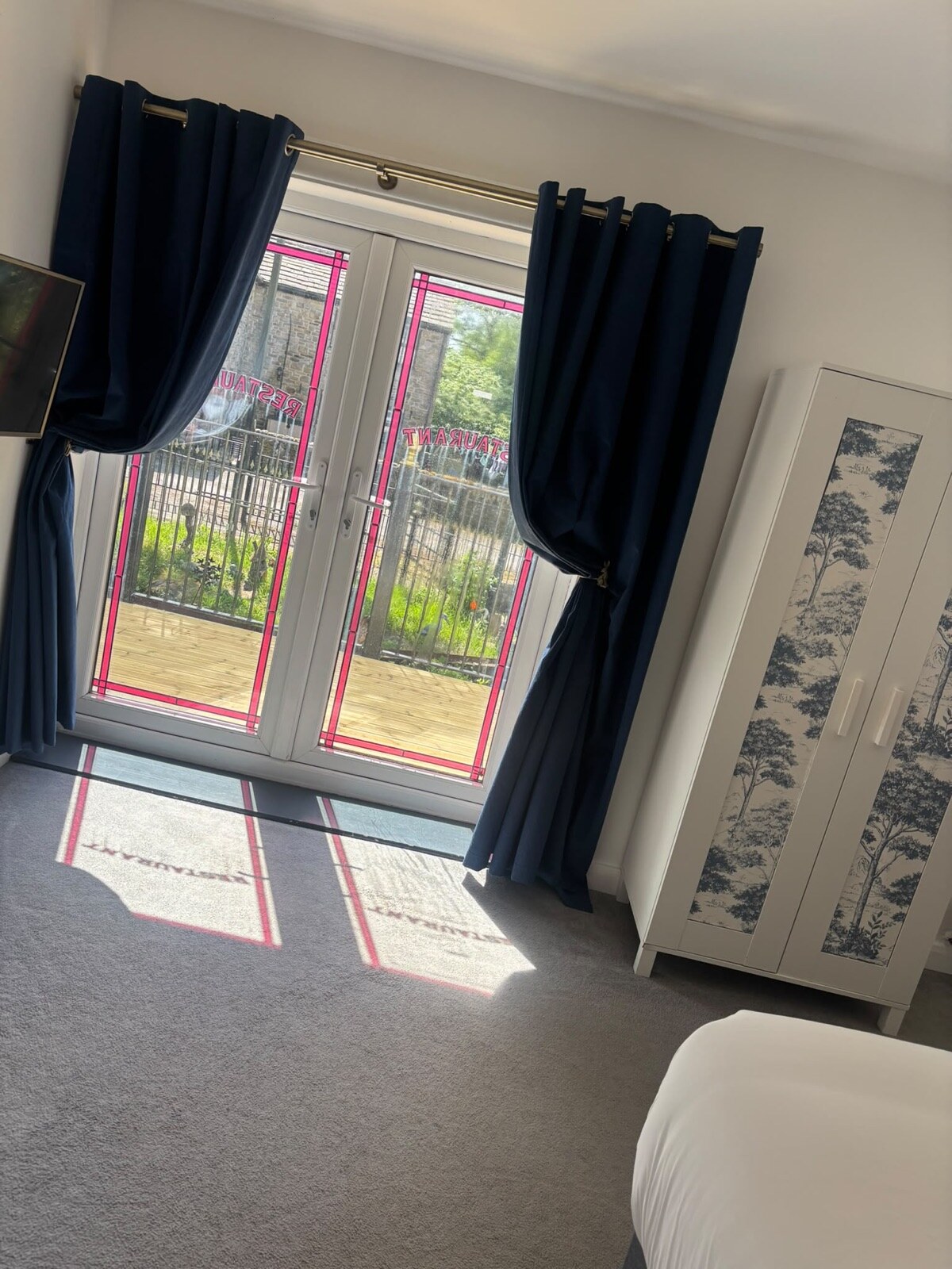 French doors opening from the bedroom onto the decking