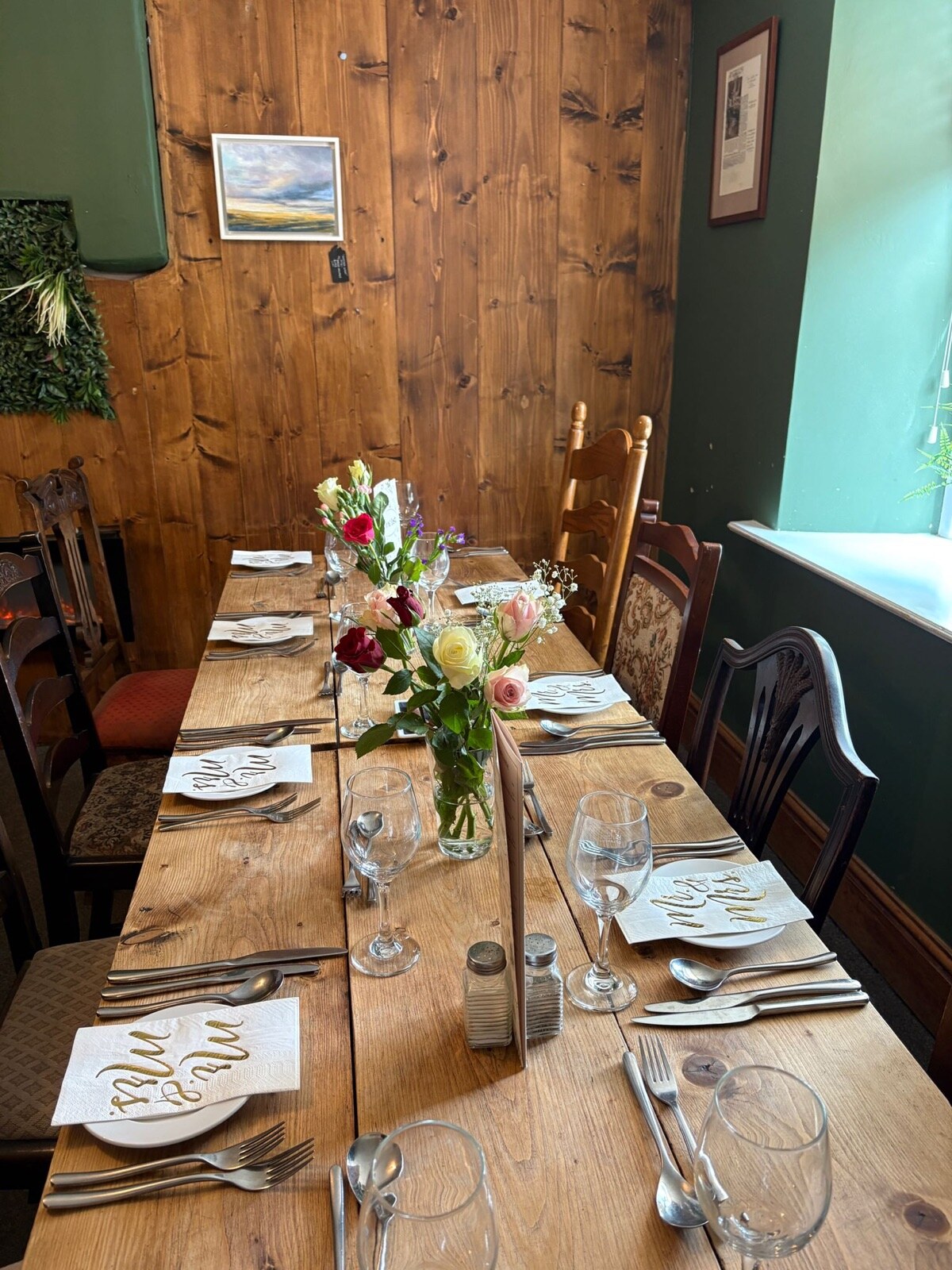 A wedding table dressed with place settings and fresh flowers